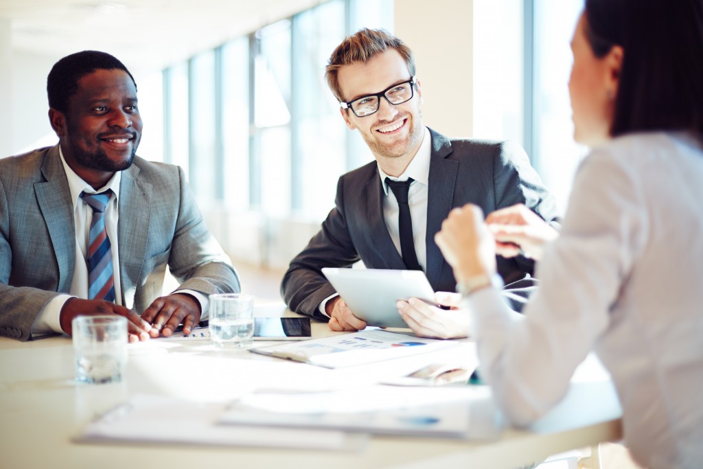 Smiling colleagues discussing working ideas in office